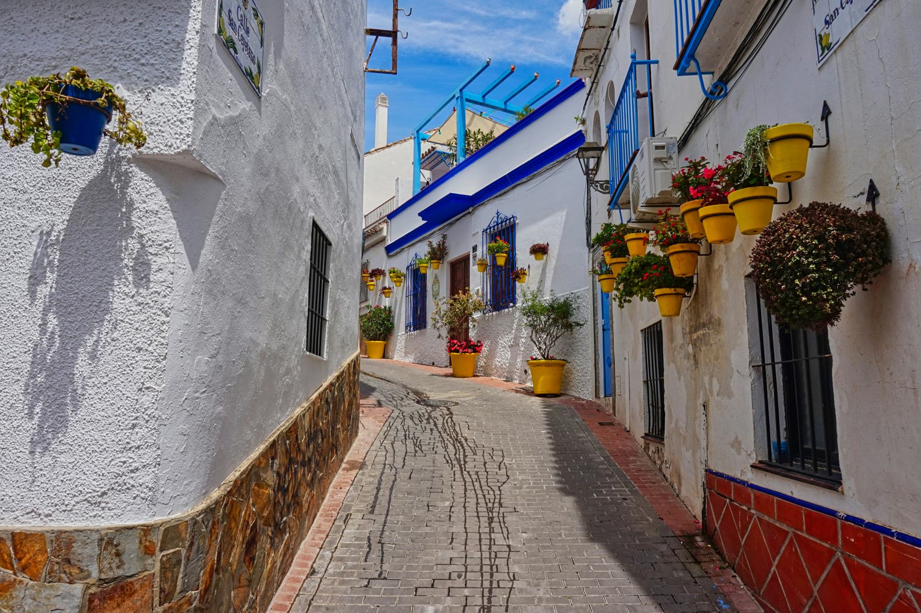 Whitewashed street with flowerpots in Estepona old town